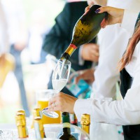 Waiter pouring champagne on a party